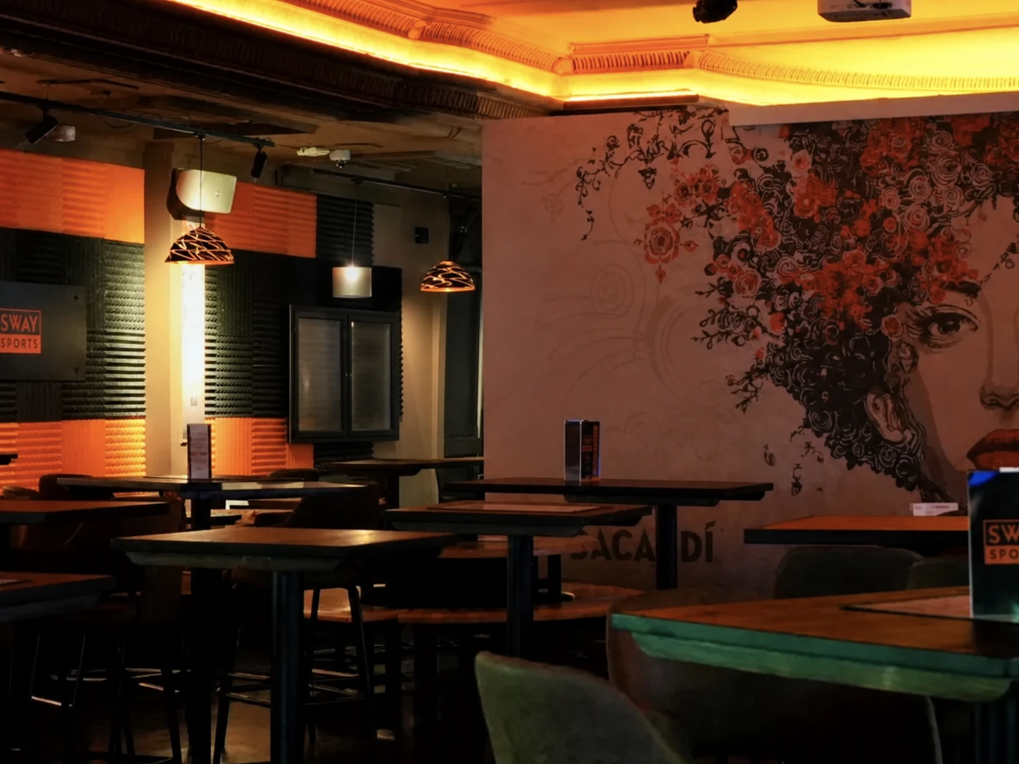 Sway Sports bar interior with feature lighting, bespoke seating and statement wall artwork